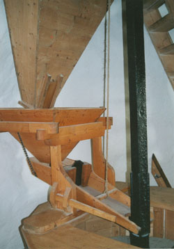 Grain hoppers, shoe, quant and runner-stone at Melin Llynnon. Photo: © 2000 D. Perkins.