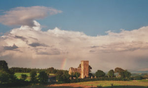 Rainbow beyond Llanidan Church (Anglesey) at 1825 GMT on the evening of the 20 August 2000. Photo: &copy; D. Perkins.