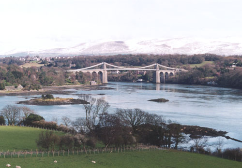 The Menai Suspension Bridge with winter snow on the Snowdonia Mountains.Photo: &copy; D. Perkins. 