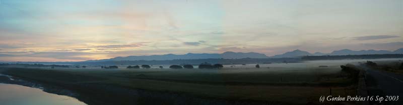 Sunrise over Malltraeth Marsh and Snowdonia on 16 September 2003. Digital Photograph (c) Gordon Perkins.