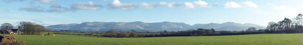 Snowdonia Mountains with 2 small fires and a few snow patches.